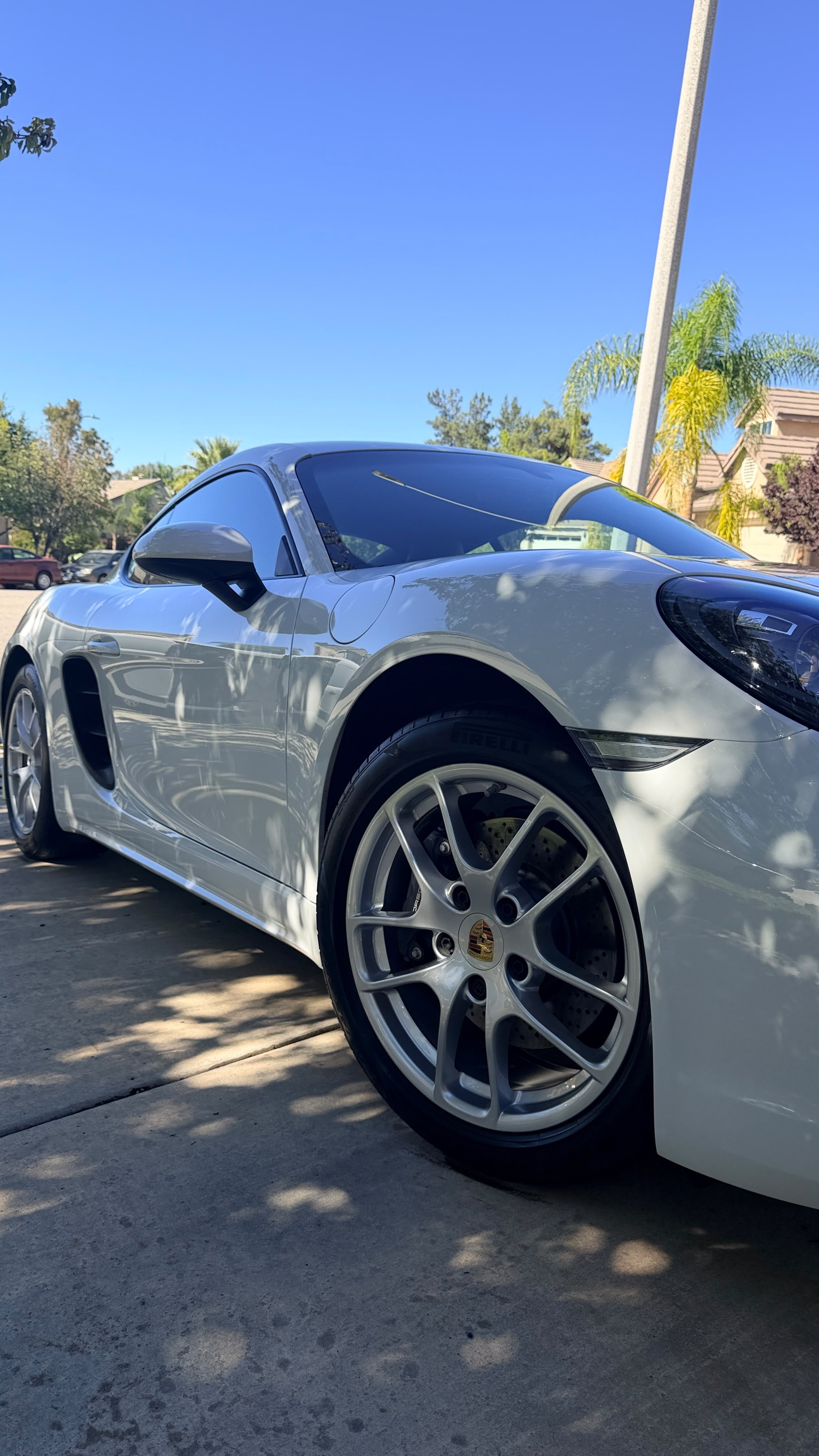 Wheel and rim detailing in Riverside & San Diego County, cleaned silver wheel and glossy paintwork on a sports coupe