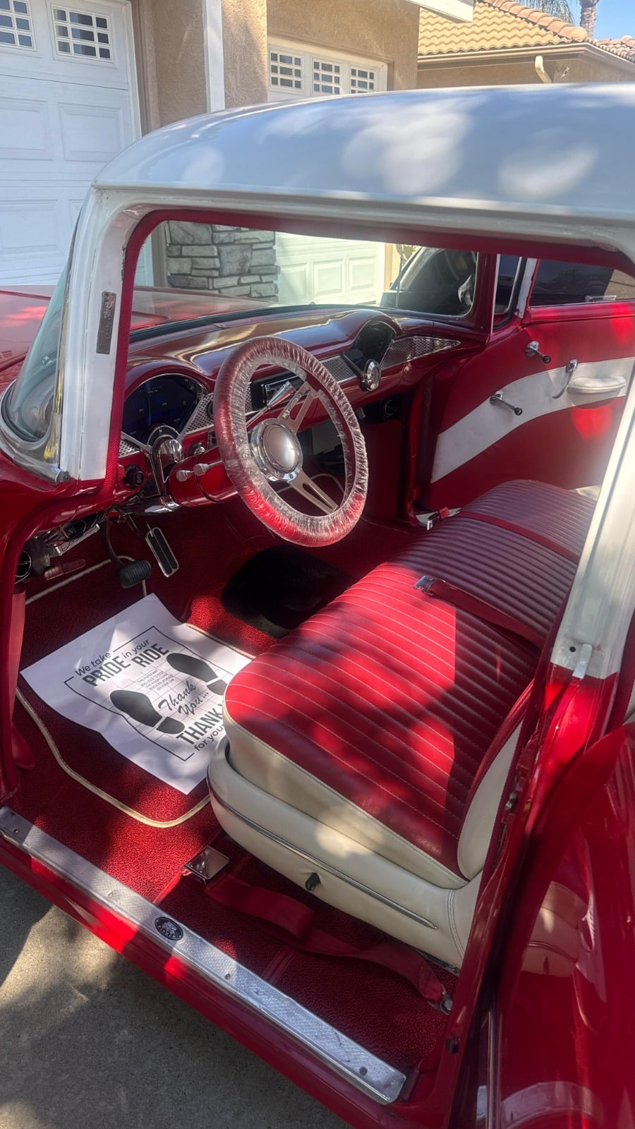 Interior car detailing in Riverside & San Diego County — classic car cabin with red and white upholstery, cleaned dashboard and steering wheel