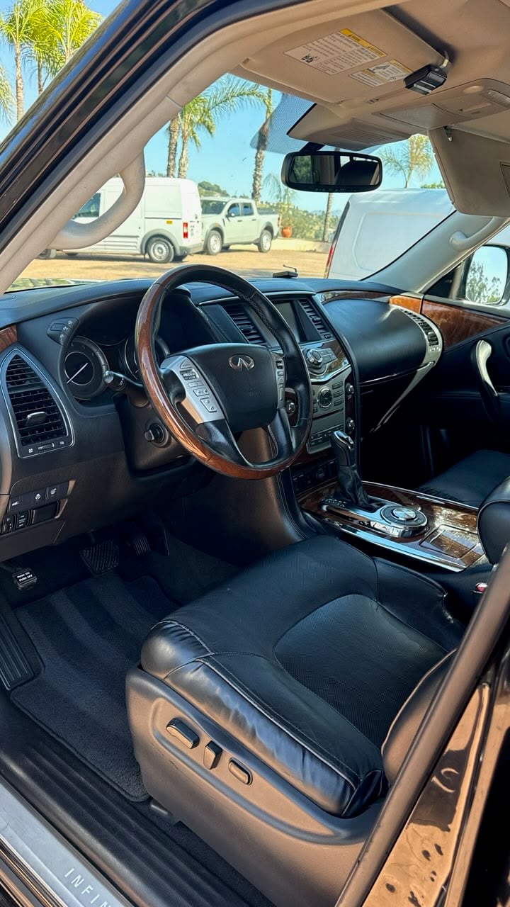 Interior car detailing in Riverside & San Diego County, SUV cabin with cleaned black leather seats, dashboard, and steering wheel