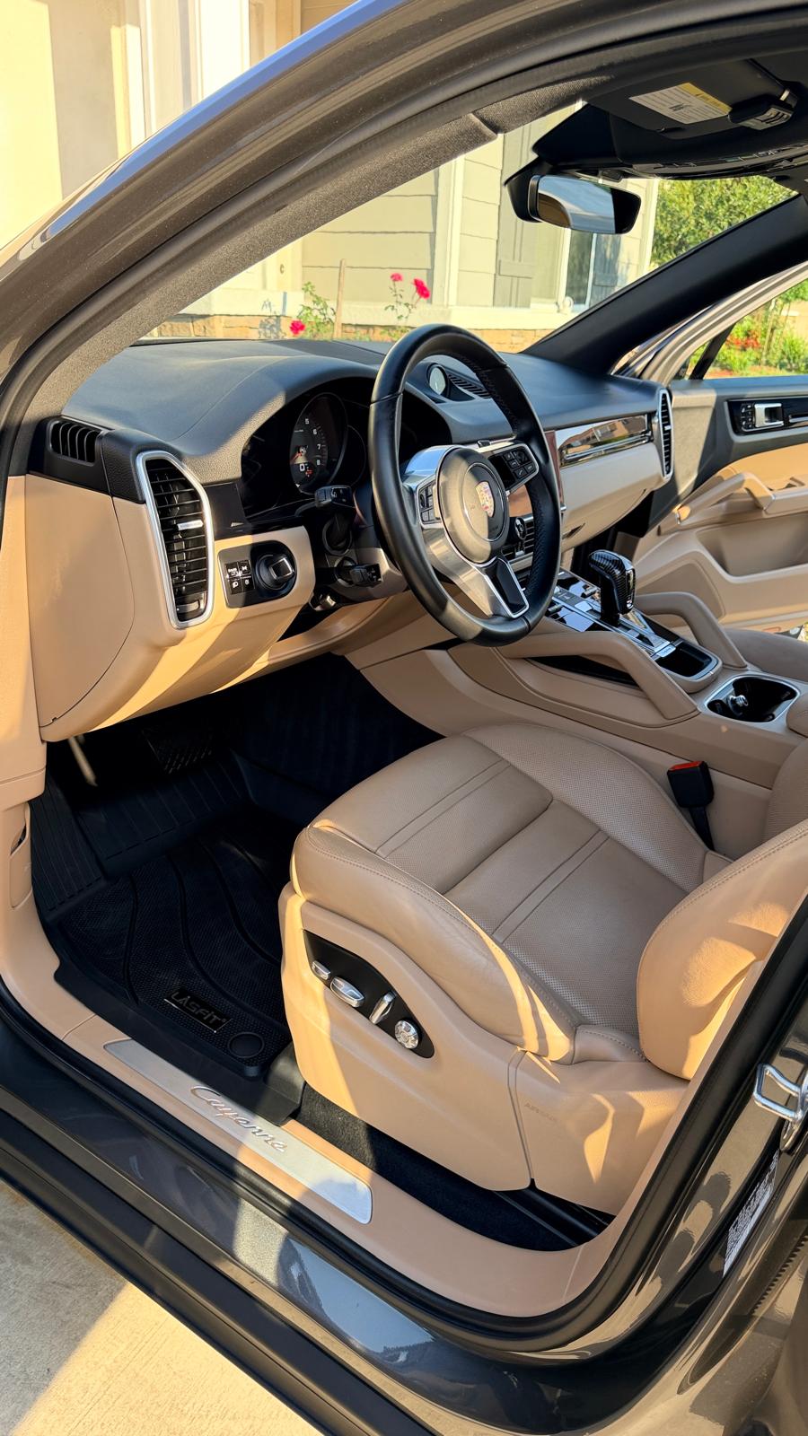 Interior car detailing in Riverside & San Diego County — SUV cabin with cleaned tan leather seats, centre console, and floor mats