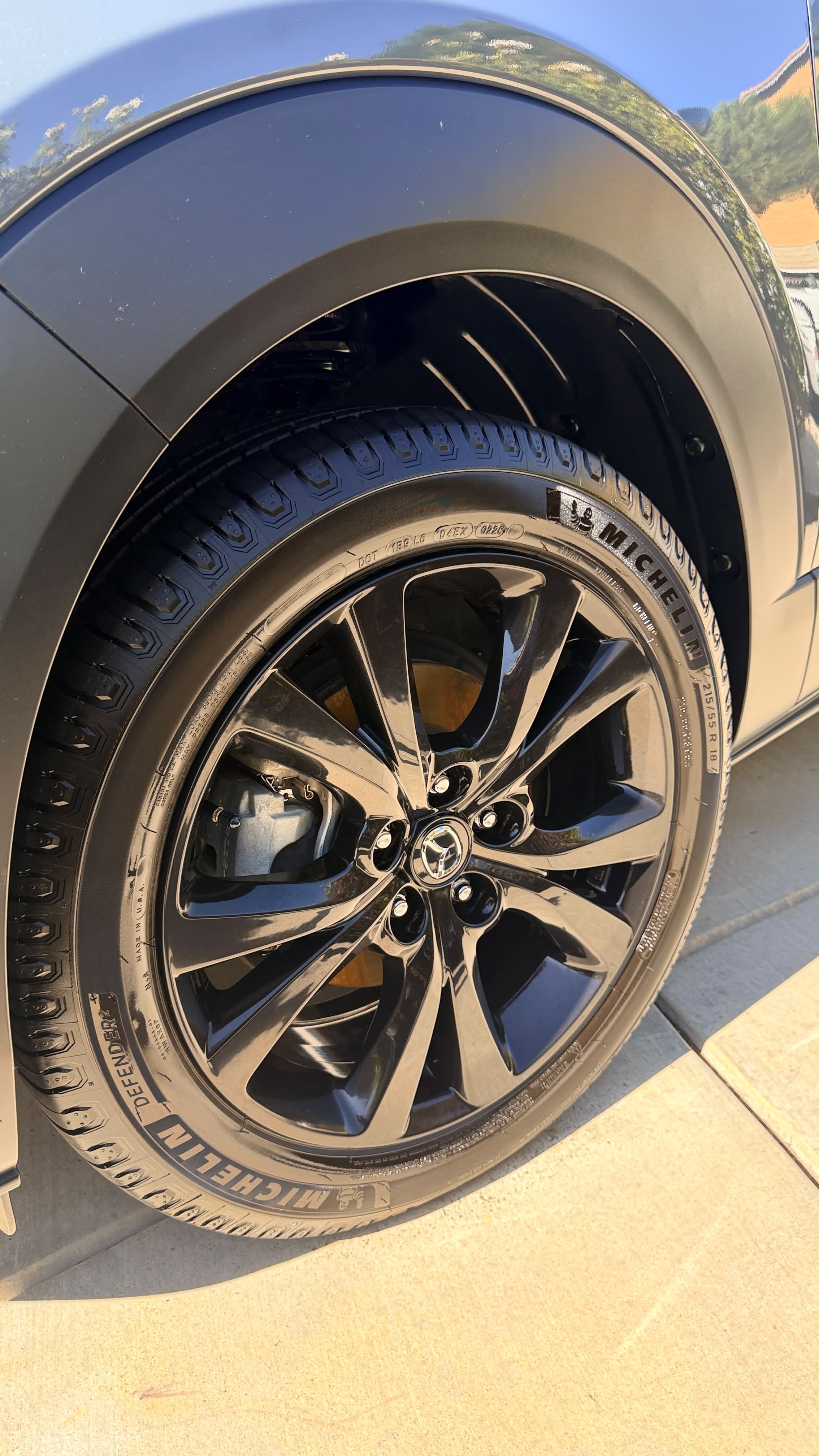 Dark gray car and gloss black wheel after a spot-free mobile wash in Menifee, California, where hard water spots on car paint show worst on dark finishes