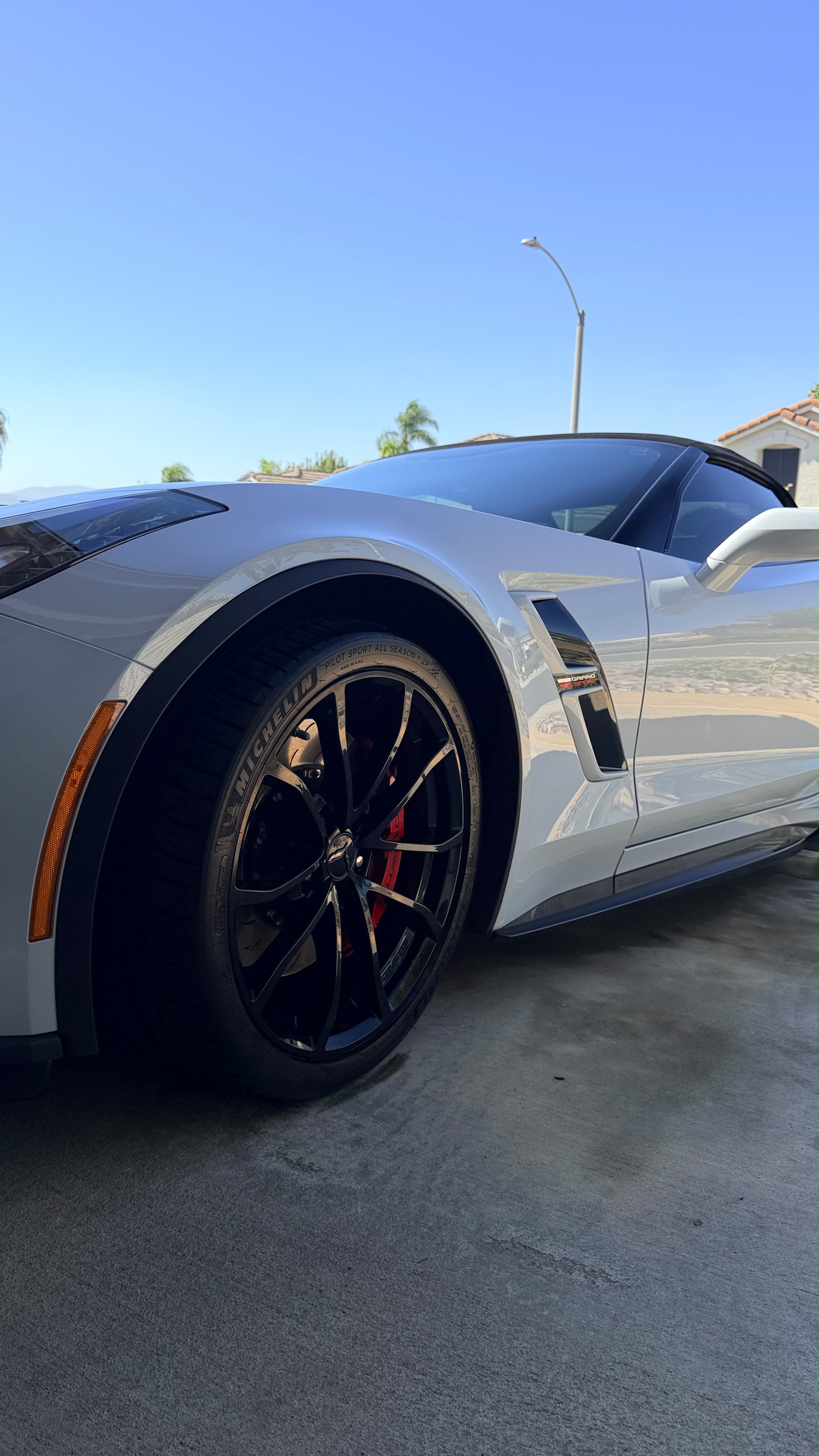 Silver Corvette with gloss black wheels and red brake calipers after a detail, the level of finish car show prep in Temecula and Riverside County aims for