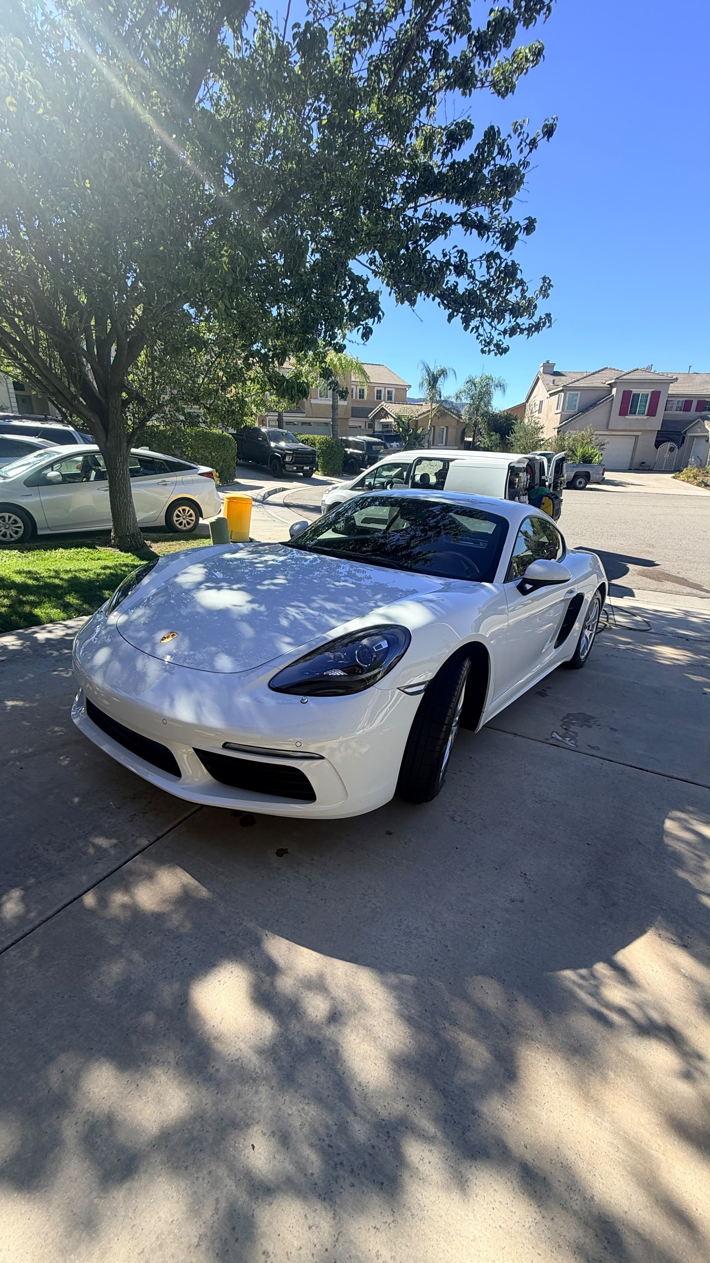 Clean white sports coupe with glossy, well-kept paint after a full exterior detail, showing how car detailing protects resale value in Riverside and San Diego County